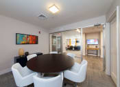 Thumbnail 20 of 24 - Bright common area with round dining table and contemporary decor