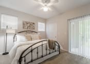 Thumbnail 6 of 15 - Bedroom with walk-in closet and private patio  at Edgewood Village, Lewisville, TX