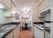 Thumbnail 7 of 11 - Galley-style kitchen at Garden Park, Irving, 75062