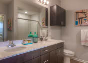Thumbnail 67 of 78 - a bathroom with two sinks and a toilet  at EdgeWater at City Center, Kansas, 66219
