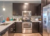 Thumbnail 68 of 78 - kitchen with stainless steel appliances  at EdgeWater at City Center, Lenexa, KS, 66219