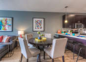 Thumbnail 70 of 78 - a dining area with a table and chairs and a kitchen in the background  at EdgeWater at City Center, Lenexa, 66219