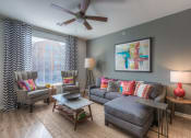 Thumbnail 71 of 78 - a living room with gray walls and a ceiling fan  at EdgeWater at City Center, Lenexa, KS, 66219