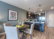 Thumbnail 73 of 78 - a kitchen and dining area with grey walls  at EdgeWater at City Center, Lenexa, Kansas