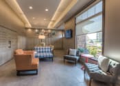 Thumbnail 42 of 78 - a lounge area with couches chairs and a television  at EdgeWater at City Center, Lenexa, KS
