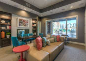 Thumbnail 43 of 78 - a living room filled with furniture and a large window  at EdgeWater at City Center, Lenexa, 66219