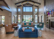 Thumbnail 37 of 78 - a large living room with couches chairs and a fireplace  at EdgeWater at City Center, Lenexa, Kansas