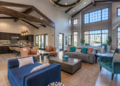 Thumbnail 38 of 78 - a spacious living room with a vaulted ceiling and large windows  at EdgeWater at City Center, Kansas