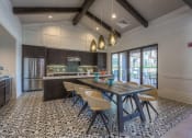 Thumbnail 41 of 78 - a kitchen with a long wooden table and yellow chairs at EdgeWater at City Center, Kansas, 66219