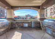 Thumbnail 8 of 78 - an outdoor kitchen with two stoves and a large window  at EdgeWater at City Center, Lenexa, Kansas