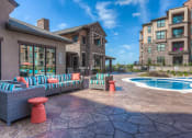 Thumbnail 10 of 78 - hot tub with couch and clubhouse in background  at EdgeWater at City Center, Kansas, 66219