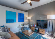 Thumbnail 63 of 78 - a living room with a ceiling fan and a flat screen tv  at EdgeWater at City Center, Lenexa, Kansas