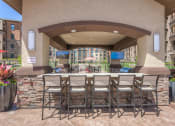 Thumbnail 17 of 78 - a bar area with grills and flat screen tv's  at EdgeWater at City Center, Lenexa, KS, 66219