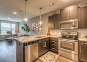 Thumbnail 36 of 53 - a kitchen with stainless steel appliances and a granite counter top  at Waterside Residences on Quivira, Lenexa, 66215