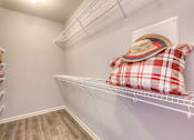 Thumbnail 44 of 53 - a closet with a shelf with a hat and pillows on it and a shelf  at Waterside Residences on Quivira, Lenexa, Kansas