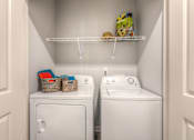 Thumbnail 45 of 53 - a small laundry room with two washers and a dryer  at Waterside Residences on Quivira, Lenexa, KS