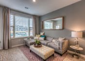 Thumbnail 47 of 53 - a living room with a couch and a table  at Waterside Residences on Quivira, Lenexa, KS