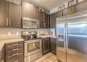 Thumbnail 38 of 53 - a kitchen with stainless steel appliances  at Waterside Residences on Quivira, Lenexa, Kansas