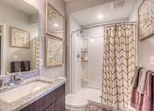 Thumbnail 49 of 53 - a bathroom with a shower and a sink and a toilet  at Waterside Residences on Quivira, Kansas
