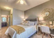 Thumbnail 48 of 53 - a bedroom with a bed and a desk with a mirror  at Waterside Residences on Quivira, Kansas, 66215