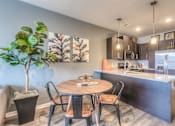 Thumbnail 37 of 53 - an open kitchen and dining room with a table and chairs  at Waterside Residences on Quivira, Lenexa