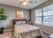 Thumbnail 41 of 53 - a bedroom with a bed and a ceiling fan  at Waterside Residences on Quivira, Lenexa, KS, 66215