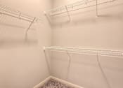 Thumbnail 42 of 53 - the walk in closet of an apartment with empty shelves  at Waterside Residences on Quivira, Lenexa, KS, 66215