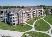 Thumbnail 4 of 53 - an aerial view of an apartment complex with green grass and trees  at Waterside Residences on Quivira, Kansas