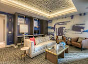 Thumbnail 27 of 53 - media lounge with work area and seating in front of a tv  at Waterside Residences on Quivira, Lenexa, Kansas