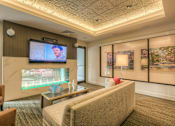 Thumbnail 25 of 53 - media lounge fireplace with seating  at Waterside Residences on Quivira, Lenexa, KS, 66215