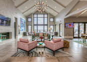 Thumbnail 20 of 53 - clubhouse entrance with seating in front of a fireplace  at Waterside Residences on Quivira, Kansas