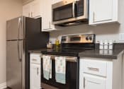 Thumbnail 8 of 36 - Kitchen with stainless steel appliances at Mission Trails Apartments San Diego, California, 92119