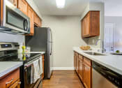Thumbnail 26 of 36 - Kitchen with stainless steel appliances at Mission Trails Apartments San Diego, San Diego