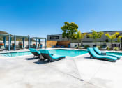 Thumbnail 31 of 36 - Outdoor pool area with lounge chairs at Mission Trails Apartments San Diego, California