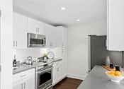 Thumbnail 31 of 50 - Kitchen with appliances white interior at 65 Bay Street, Jersey City, NJ
