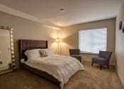 Thumbnail 22 of 50 - Bedroom with lamp at Commons at Redwood Creek Apartments, Oregon