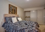 Thumbnail 25 of 50 - Bedroom with cozy bed and lamp and frame at Commons at Redwood Creek Apartments, Beaverton, OR