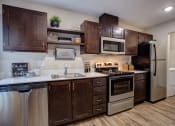 Thumbnail 15 of 50 - Wooden cabinets at Commons at Redwood Creek Apartments, Oregon, 97008