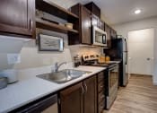 Thumbnail 16 of 50 - Wooden cabinets and appliances at Commons at Redwood Creek Apartments, Beaverton, OR, 97008