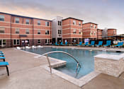 Thumbnail 9 of 11 - Pool With Relaxing Chair at The Liberty Lofts, Gainesville, TX
