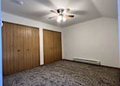 Thumbnail 4 of 21 - A room with a ceiling fan and two doors.