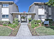 Thumbnail 1 of 28 - The image shows a pathway leading to a building with a sign that reads