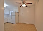 Thumbnail 18 of 28 - A room with a ceiling fan and a refrigerator.