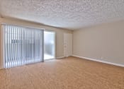 Thumbnail 20 of 28 - A room with wooden flooring and a sliding door with blinds.