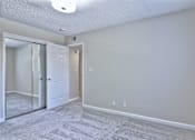 Thumbnail 22 of 28 - A room with a carpeted floor and a white door.