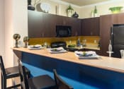 Thumbnail 45 of 55 - a kitchen with a long counter top and a stainless steel refrigerator