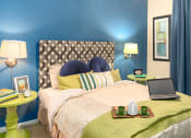 Thumbnail 47 of 55 - a bedroom with blue walls and a bed with a laptop on it