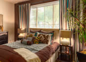 Thumbnail 38 of 55 - a bedroom with a large bed in front of a large window