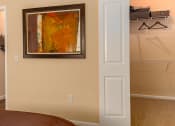 Thumbnail 40 of 55 - a bedroom with a closet and a painting on the wall