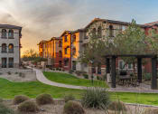 Thumbnail 20 of 55 - a group of houses in a row with a sunset in the background